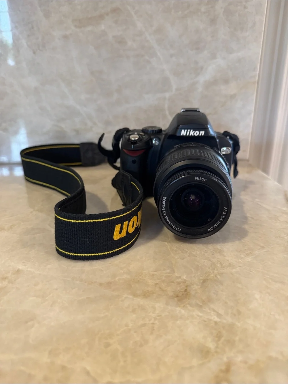 Nikon Black DSLR with Black and Yellow Branded Strap